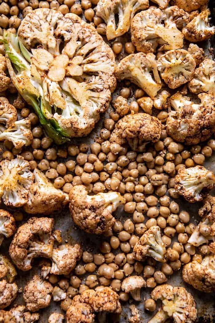 Cauliflower and chickpeas on baking sheet before roasting