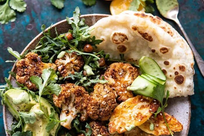 overhead close up horizontal photo of Cauliflower Shawarma with Green Tahini and Fried Halloumi