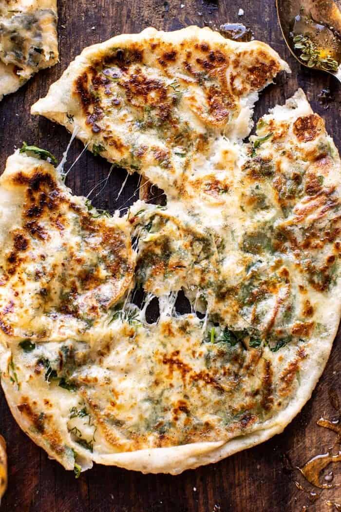 overhead close up photo of Cheesy Herb Stuffed Naan