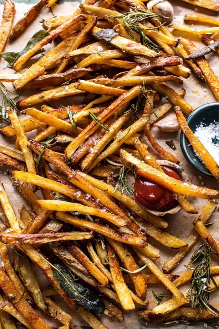overhead photo of Oven Baked Tuscan Fries with a couple fries sitting in ketchup