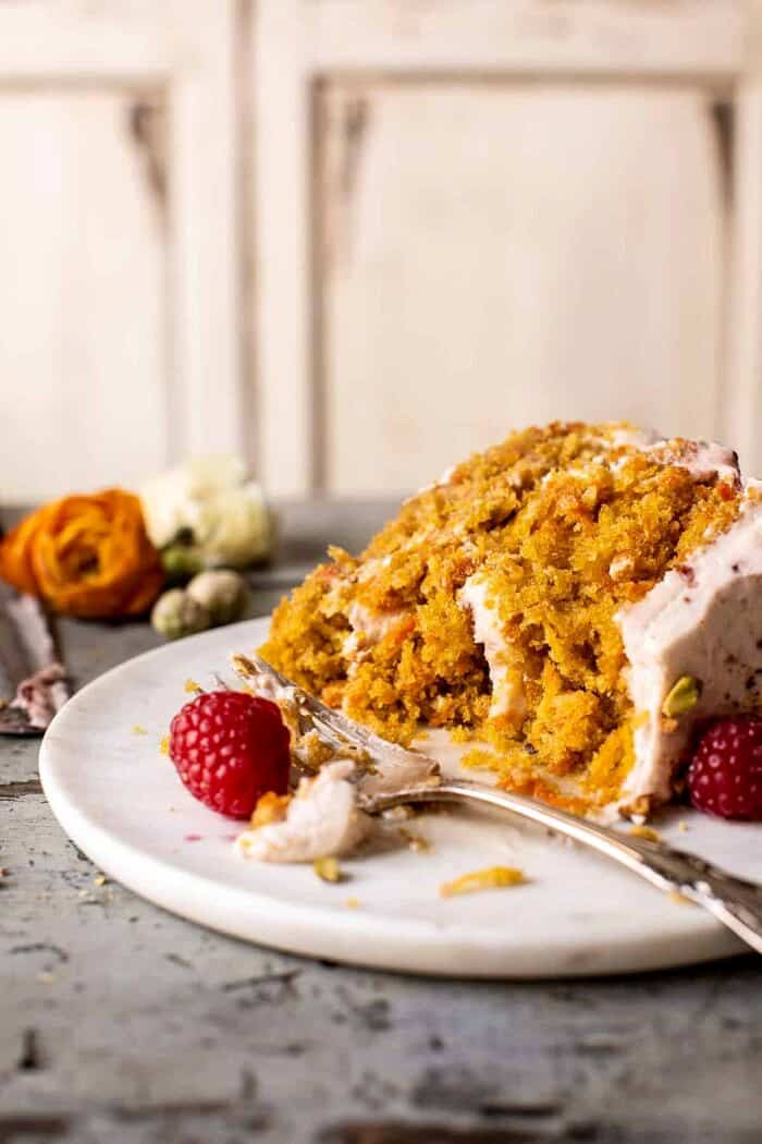 side angled photo of Coconut Carrot Cake slice with fork on plate