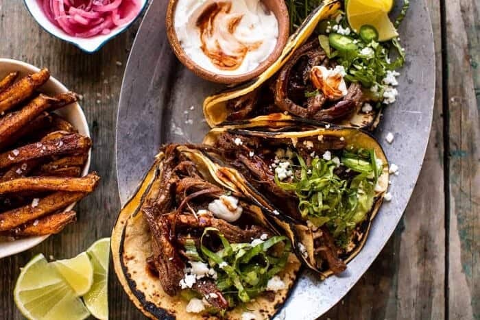 overhead photo of Crockpot Carne Asada Tacos with Cilantro Lime Garlic Sauce