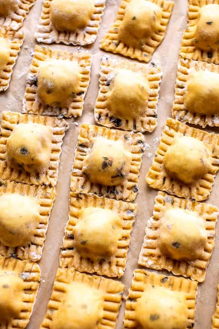 prep photo of raw Cheese Ravioli on parchment paper before cooking 