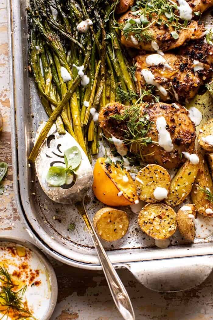 overhead photo of Sheet Pan Lemon Rosemary Dijon Chicken and Potatoes with Feta Goddess Sauce 