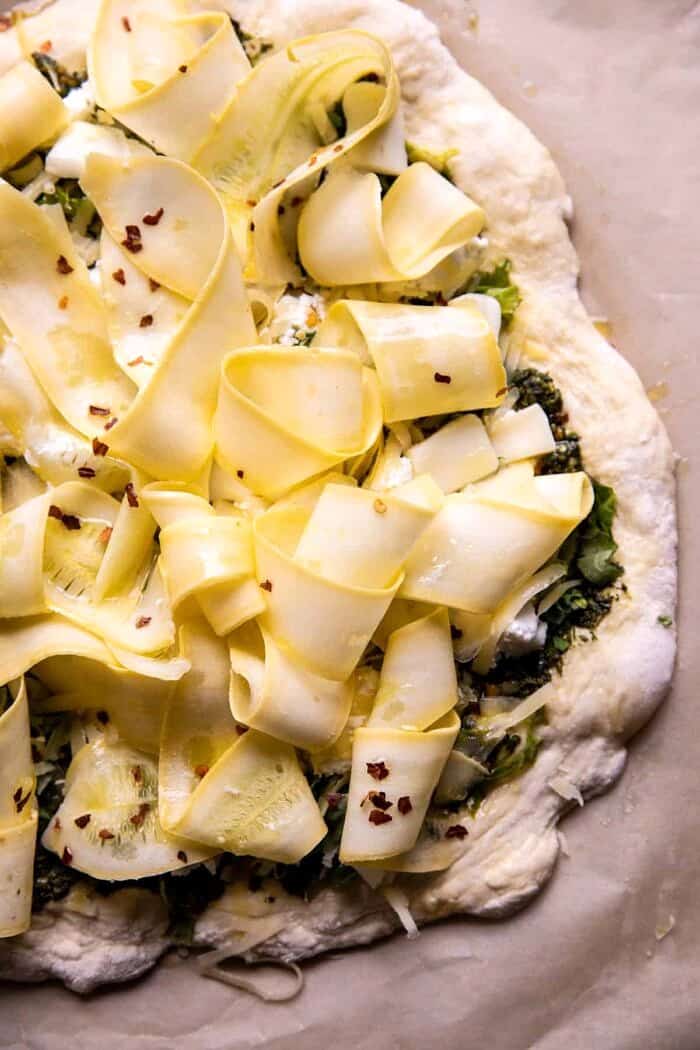 overhead prep photo of Garden Greens Goddess Pizza on baking sheet before baking 
