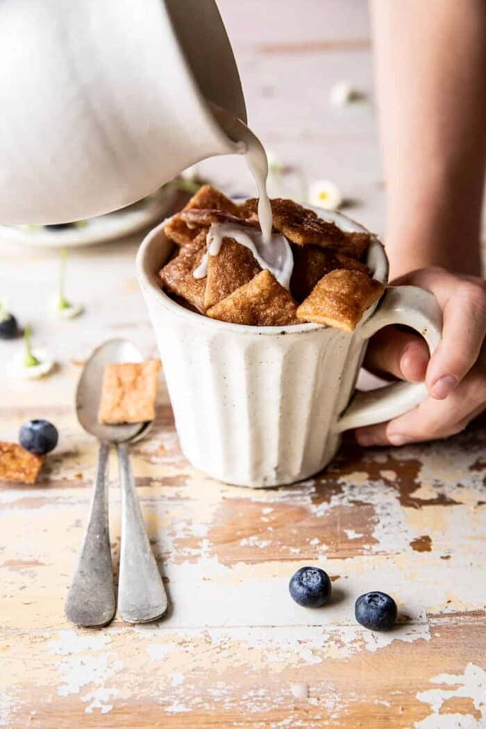 Homemade Cinnamon Toast Crunch in mug with milk being poured over cereal