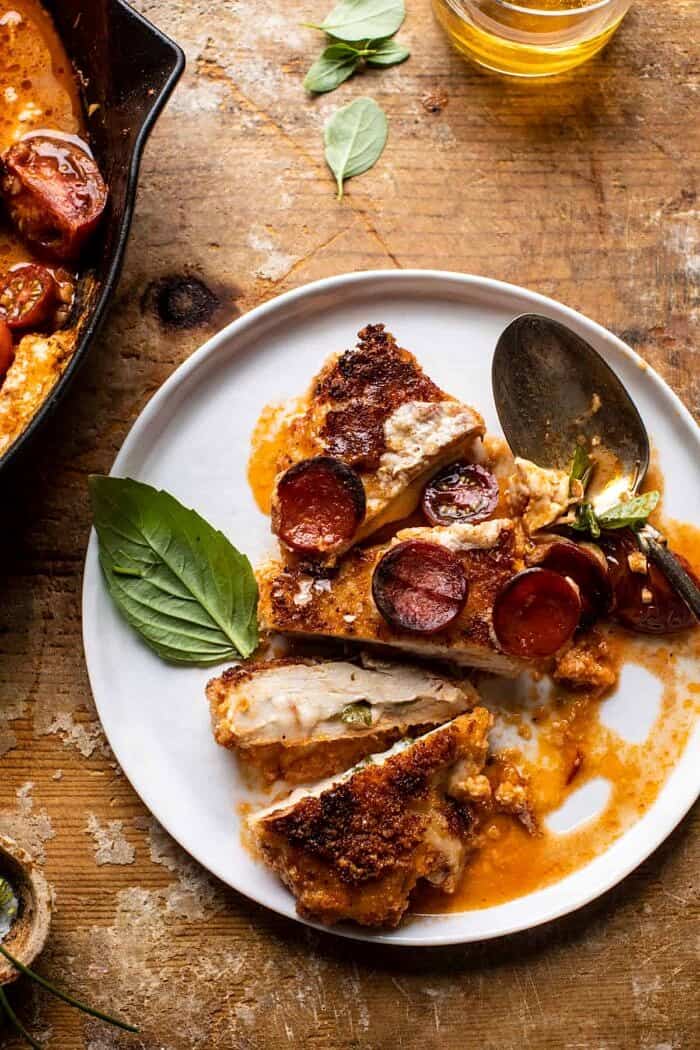 overhead close up photo of Skillet Cheesy Pepperoni Pizza Chicken plated and sliced