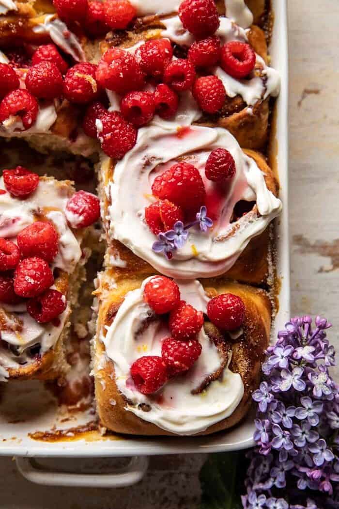 overhead close up photo of Raspberry Lemon Brioche Rolls with Whipped Ricotta Cream in baking dish