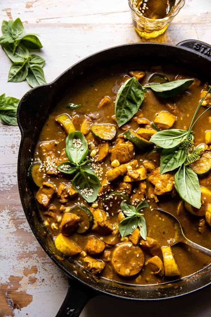 overhead photo of Spicy Coconut Basil Chicken Curry with Garden Vegetables in skillet 