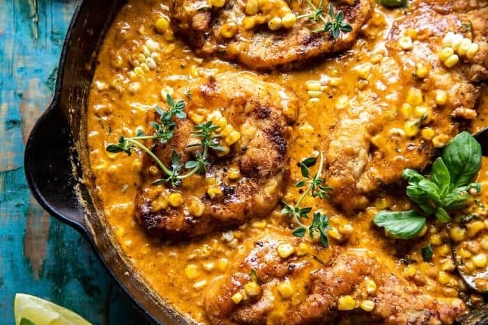 overhead horizontal photo of Creamy Cajun Skillet Chicken Lazone with Herby Corn 