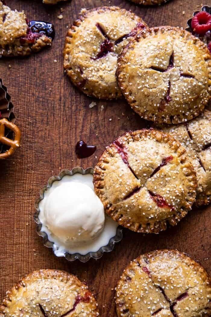 overhead photo Jammy Raspberry Cream Pretzel Hand Pies with ice cream