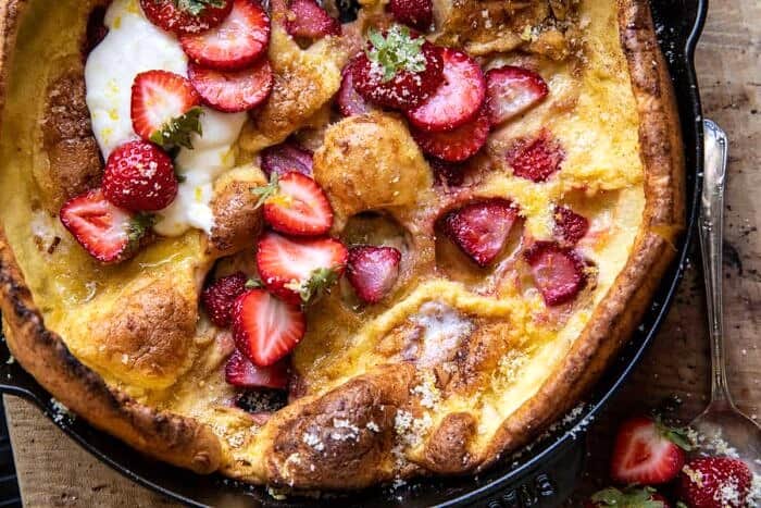 overhead horizontal photo of Lemon Strawberry Dutch Baby with Ricotta Cream