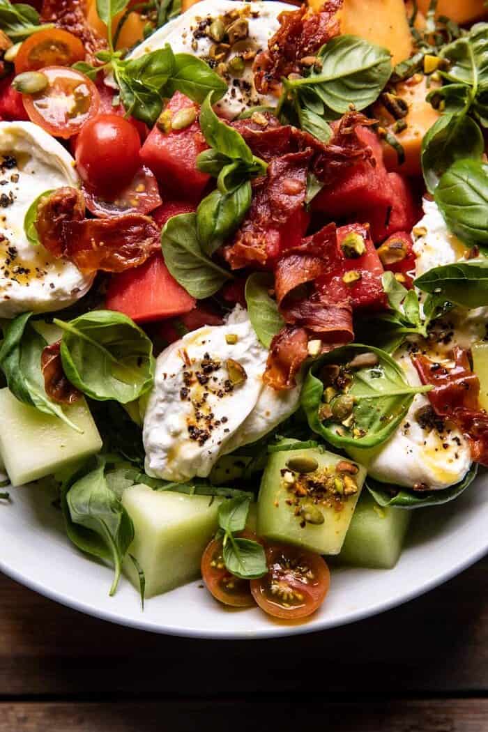 overhead close up photo of Melon Basil Burrata Salad with Crispy Prosciutto