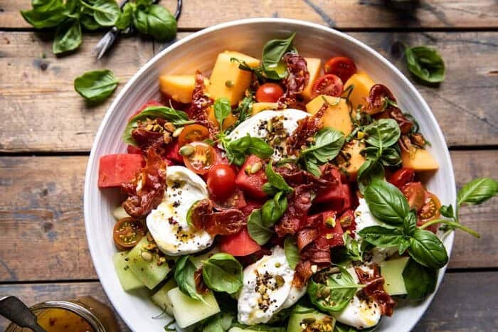 overhead horizontal photo of Melon Basil Burrata Salad with Crispy Prosciutto