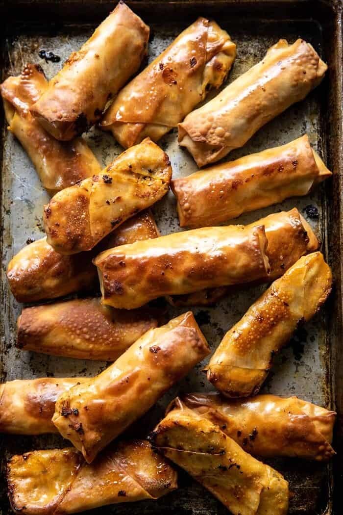 overhead photo of Baked Buffalo Chicken Egg Rolls after baking on baking sheet