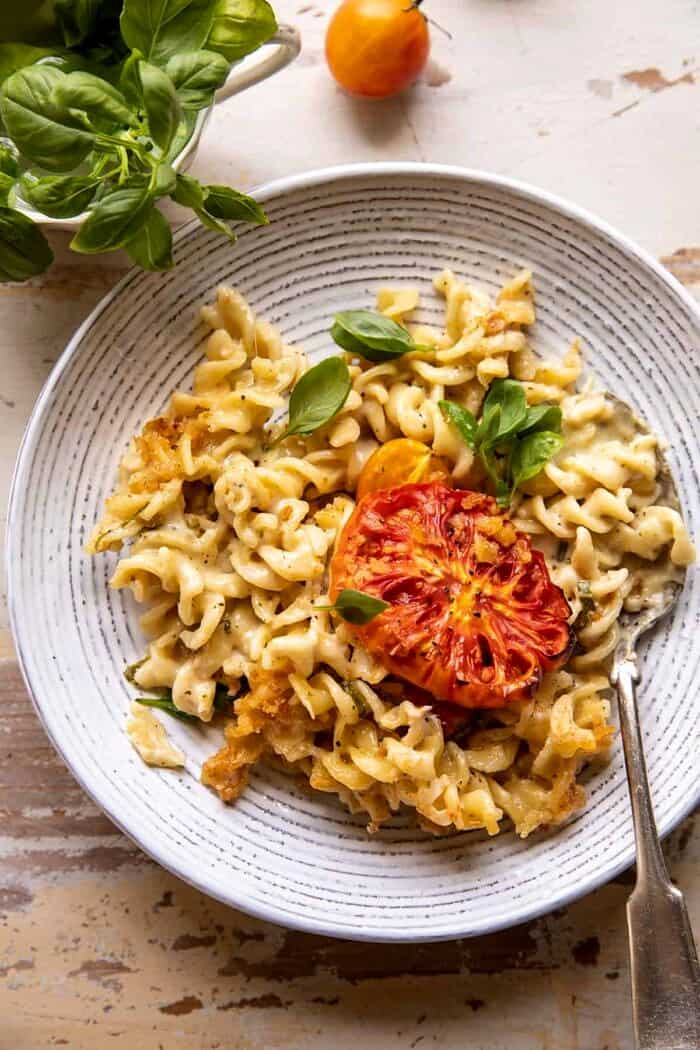 overhead photo of One Pot 4 Cheese Caprese Mac and Cheese on serving plate with spoon