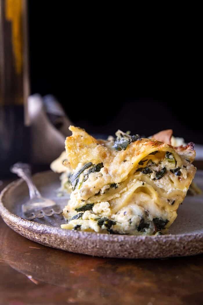 side angled photo of 4 Cheese Sage Pesto Florentine Lasagna | halfbakedharvest.com
