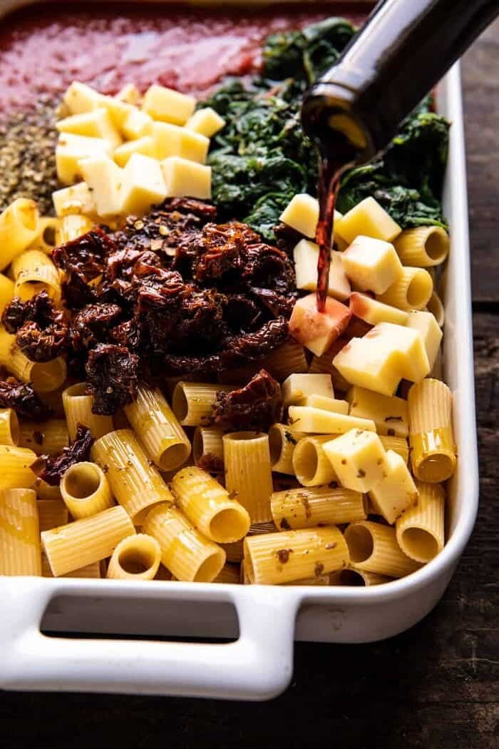 side angled photo of One Pan 4 Cheese Sun-Dried Tomato and Spinach Pasta Bake before baking