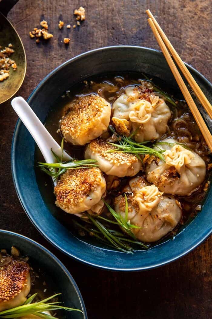 overhead photo of Sesame Chicken Dumplings in Spicy Broth with Garlic Crisps