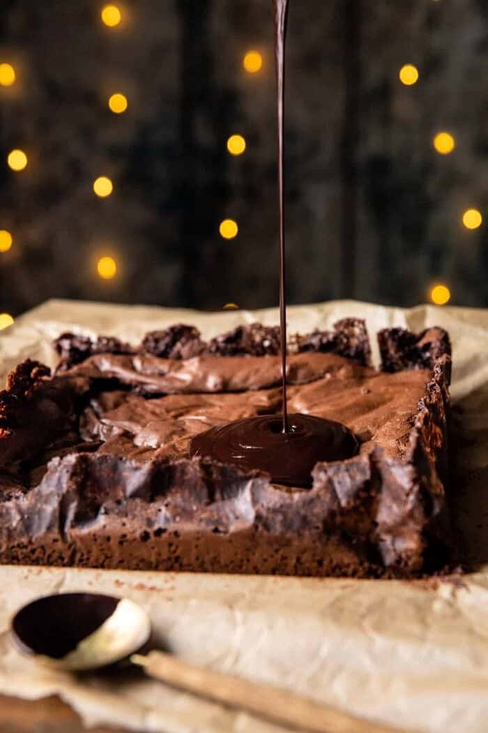 side angle photo of Peanut Butter Truffle ganache being poured onto Brownies