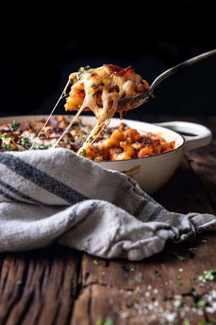 side angle photo of cheese being pulled out of pan