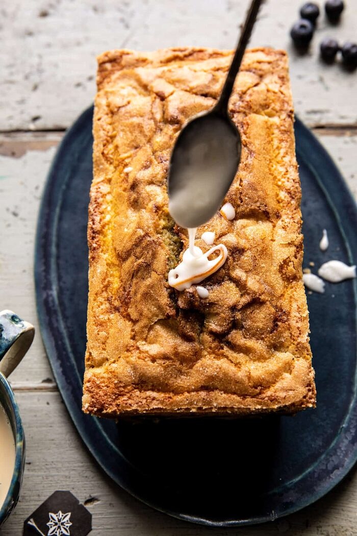 glaze being drizzled on cake