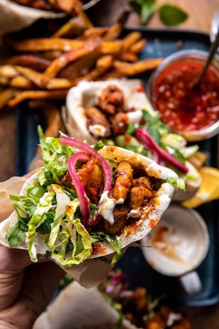 overhead photo of Roasted Turmeric Chicken Pita in hand 