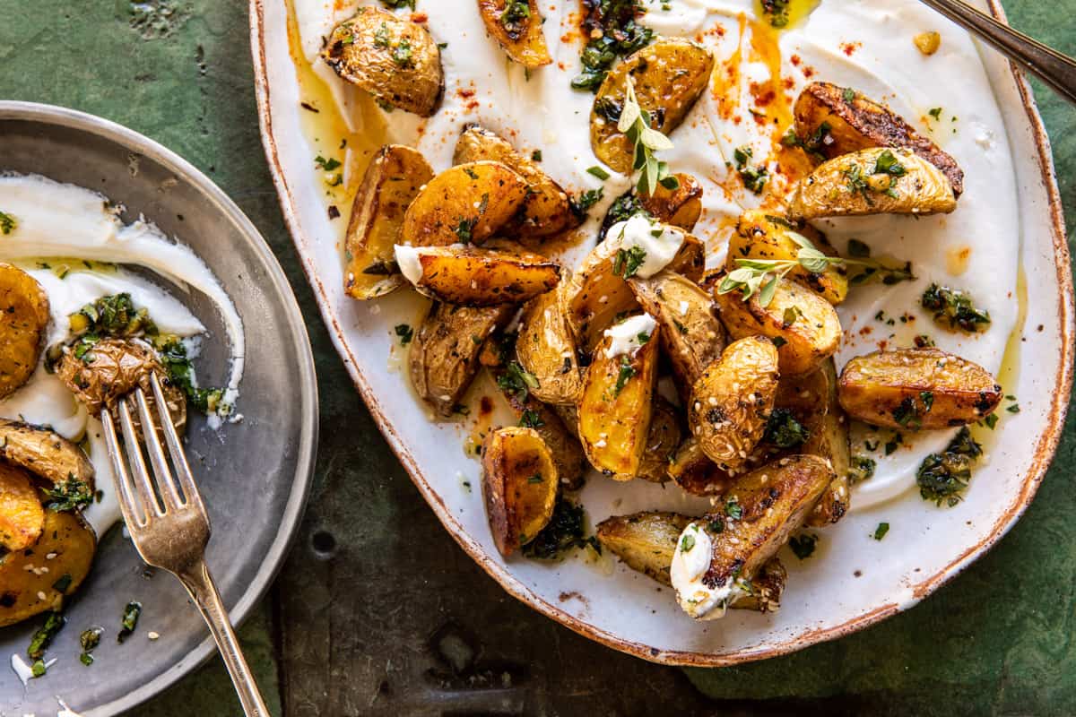 Crispy Oregano Roasted Potatoes with feta on plate with fork 