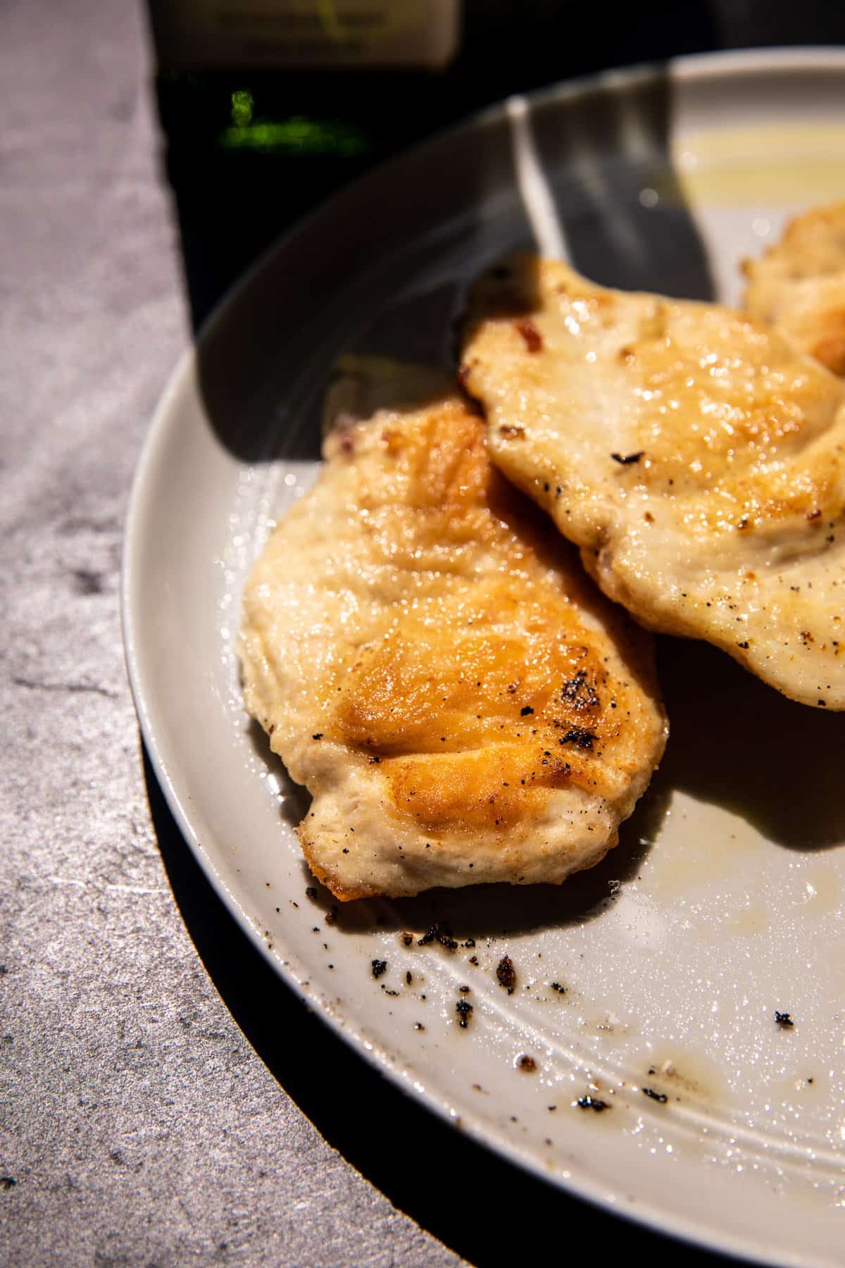 chicken on plate after cooking in skillet 